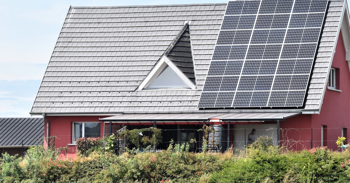 A red house with solar panels on the roof in Seppois-le-Bas, illustrating clean energy.